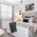 a bedroom with a bed and a fan