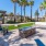 a patio with palm trees and a picnic table