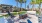 a patio with palm trees and a picnic table