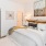 a bedroom with a bed and a fan