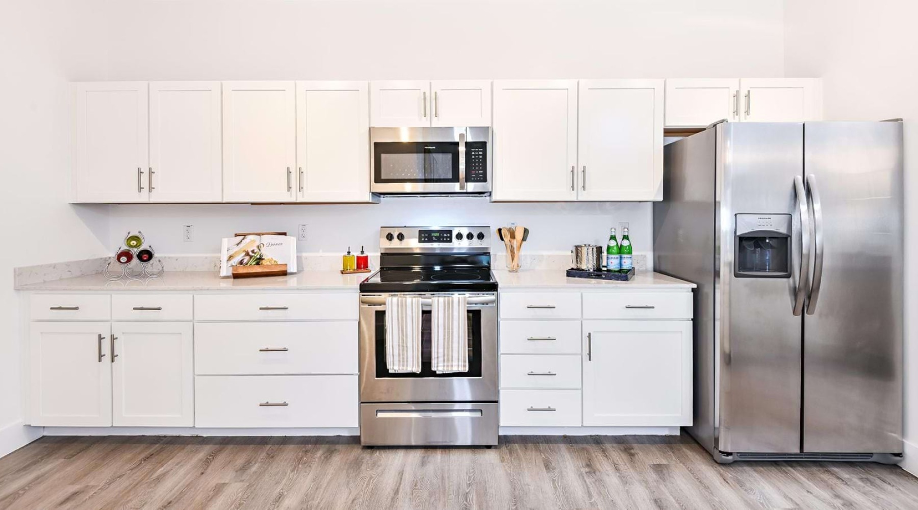 A kitchen with white cabinets